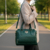 Dark green genuine leather handbag with crocodile-embossed texture, dual top handles, and gold-tone hardware accents