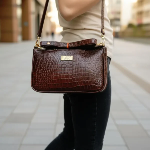 Deep rich brown genuine leather handbag with crocodile-embossed texture, structured design, and gold-tone hardware