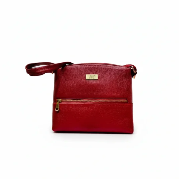 Ruby red genuine leather Lyra sling bag with a sleek, compact design and adjustable strap for versatile everyday use.