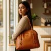 Tan genuine leather tote bag with natural grain texture and a spacious, elegant design perfect for everyday use.